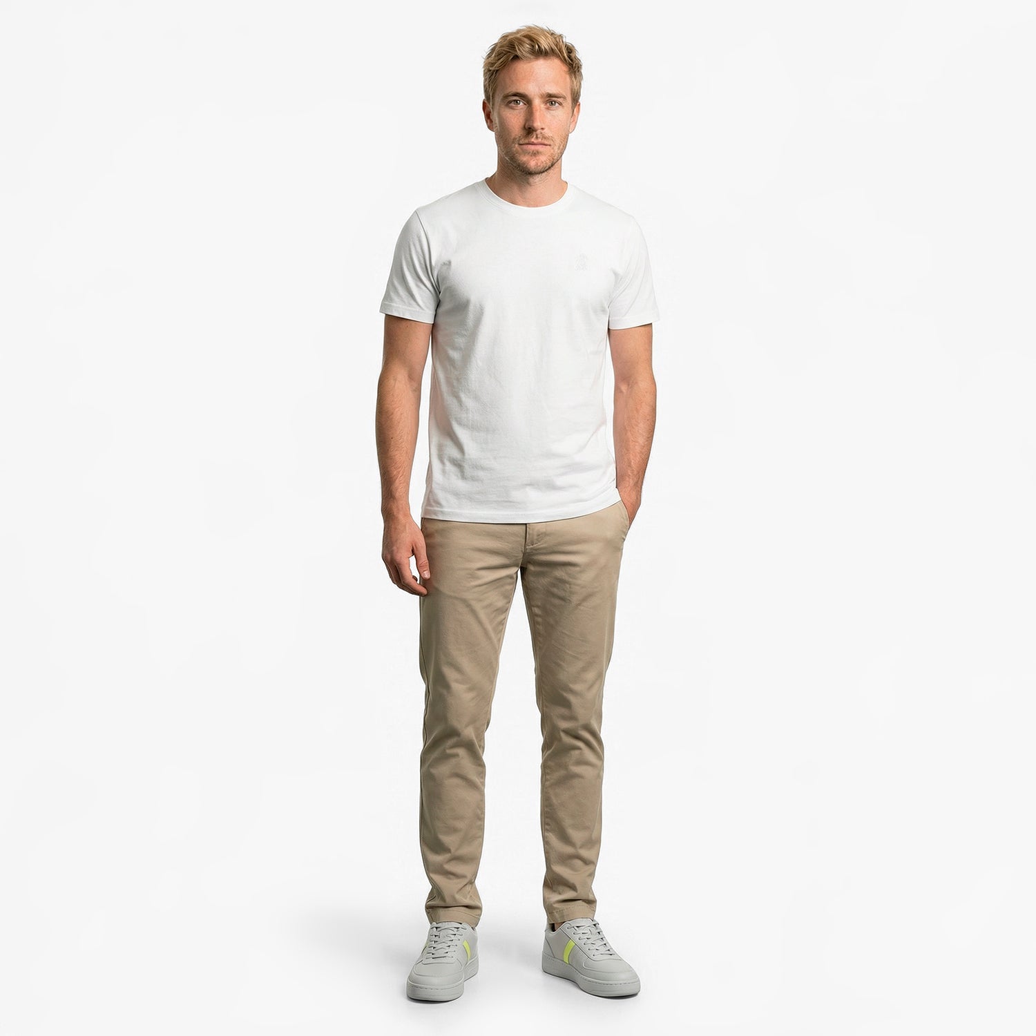 Man wearing a white t-shirt and beige pants on a white background