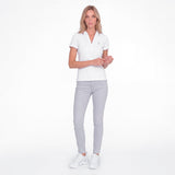 Women wearing a white polo with an embroidered dog logo on a white background