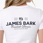 A woman is shown from the back wearing a white short-sleeve T-shirt with a black printed graphic on the upper back. The graphic reads 'ESTD 2015 JAMES BARK Courtside Division PRIVÉ STATE OF MIND' with a small illustrated figure in the center.
