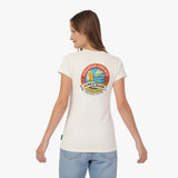 A woman is shown from the back wearing a cream-colored T-shirt with a colorful circular graphic on the upper back.