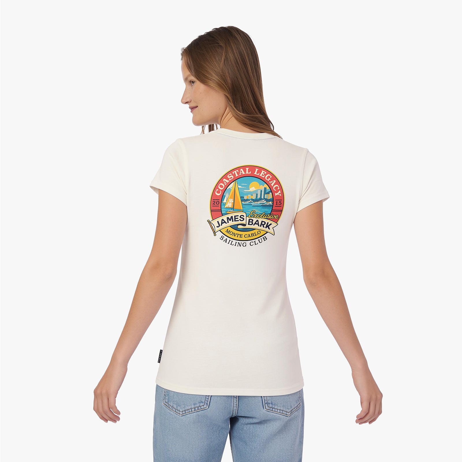 A woman is shown from the back wearing a cream-colored T-shirt with a colorful circular graphic on the upper back.
