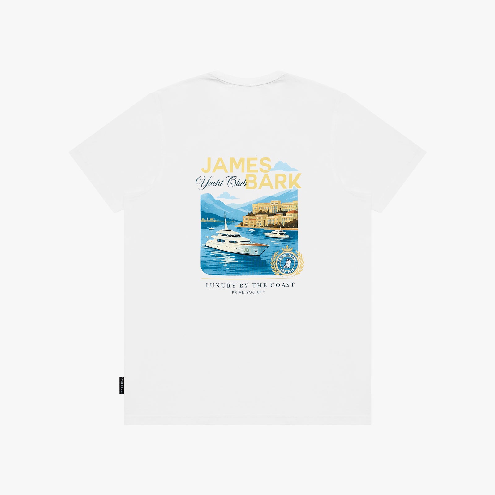 A white T-shirt with a colorful graphic print featuring a yacht, a coastal castle, and the text 'JAMES BARK Yacht Club' and 'LUXURY BY THE COAST'.