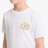 A child wearing a white short-sleeve crewneck t-shirt with a gold and navy blue emblem printed on the left chest.