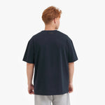 Back view of a man wearing a dark blue t-shirt on a white background