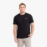 A man wearing a black short-sleeve crewneck t-shirt with a small white embroidered logo