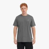 Man wearing a gray t-shirt with a small logo on a white background