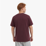Back view of a man wearing a maroon t-shirt on a white background