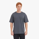 Man wearing a plain gray t-shirt on a white background